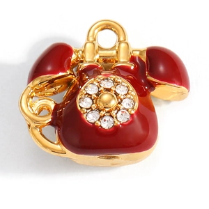 Macro detail of red enamel vintage telephone charm with sparkling gold plating and crystals