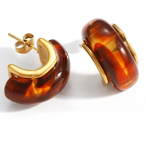 Detailed close-up of C-shaped amber resin earrings with 18K gold-plated stainless steel base