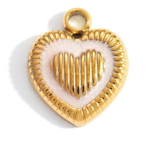 Detailed macro view of a heart pendant featuring gold ridges and pink pearlescent enamel