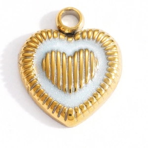 Macro detail of a double-layer gold starfish heart pendant with white enamel and 18K plating