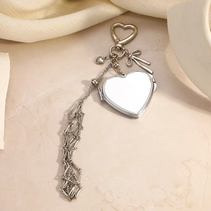 Silver stainless steel heart photo locket with bow charm and long tassel on carabiner