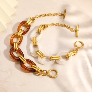 Detail of stylish resin linked bracelet with amber and milk white tones and OT clasp
