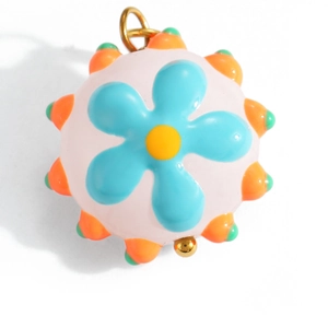 Close-up of a pink enamel mushroom flower pendant with sky blue petals and gold ring