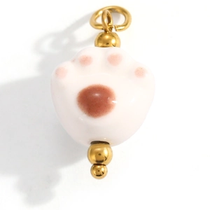 Detail of a white and pink cat paw pendant with gold beads and metal jump ring
