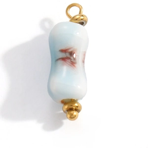 Detail showing gradient blue glazed cylindrical pendant with gold caps and red patterns
