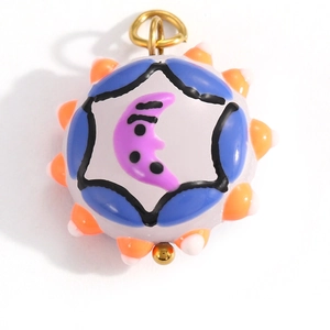 Detail of colorful round celestial pendant with purple moon and orange spiked edge