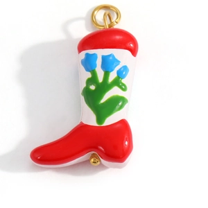 Detail of red and white enamel boot pendant with blue floral patterns and gold ring