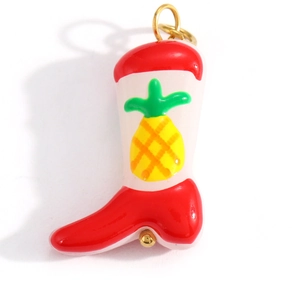 Detailed close-up of a red and white boot pendant with pineapple enamel pattern and gold ring