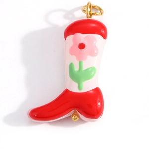 Detail of red and pink boot pendant with floral patterns and gold-tone loop and bead