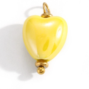 Detailed view of yellow heart enamel pendant with a gold metal loop and bottom bead