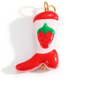 Detail of pink and red strawberry boot pendant with golden metal hanging ring