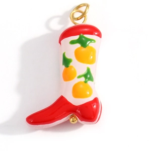 Detail of colorful cowboy boot charm pendant with floral enamel patterns for DIY jewelry