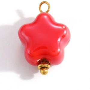Close-up of a red cherry flower pendant with glossy enamel finish and gold metal loop