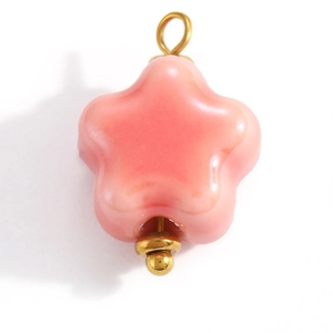Macro shot of a pink star pendant with gold metal hoop for DIY jewelry making