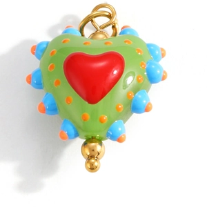 Macro shot of colorful heart-shaped pendant with vibrant enamel inlay and gold metal loop