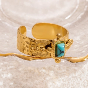 Hammered gold wide band ring featuring a rectangular turquoise stone in vintage style