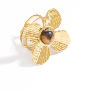 Detailed view of gold stainless steel ring with flower design and brown tiger eye stone