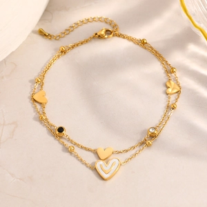 Tobillera de doble capa en acero inoxidable dorado con dijes de corazón y cristales fijos