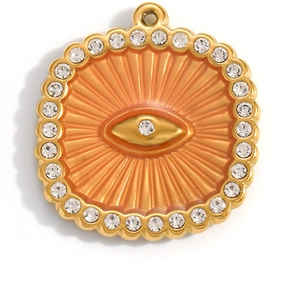 Detail of 18K gold plated evil eye pendant with orange enamel and clear rhinestones
