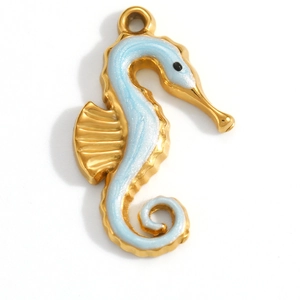 Detail view of a gold seahorse pendant with blue enamel and polished metallic frame