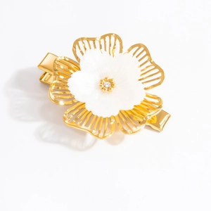 Elegant gold flower hair clip with pearl petals and sparkling crystal accents on white background