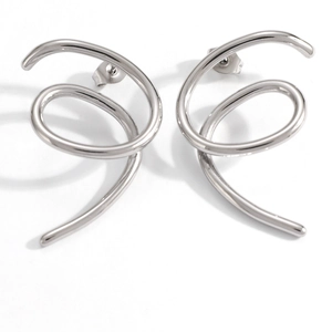 Macro shot of silver spiral earrings in polished stainless steel with a sleek dynamic twist