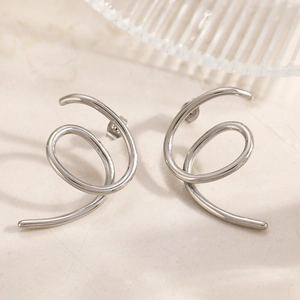 Detailed view of minimalist silver spiral earrings with high-polish metallic finish