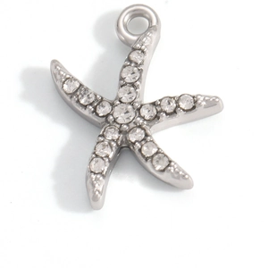 Macro shot of a starfish pendant charm with sparkling pavé crystals and silver finish