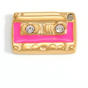 Detailed view of cassette tape pendant in gold finish with pink enamel and crystals