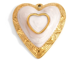 Detailed view of heart-shaped gold-plated pendant with white pearlescent enamel inlay