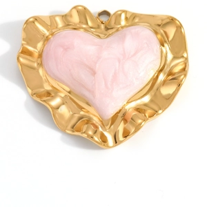 Detailed macro view of heart-shaped 18K gold-plated pendant with pink enamel inlay