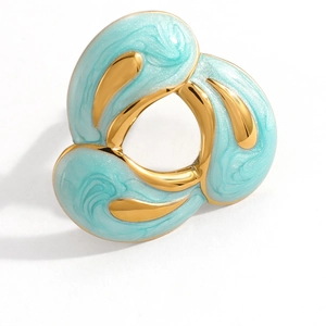 Detailed macro view of gold plated teardrop ring featuring blue marble enamel texture