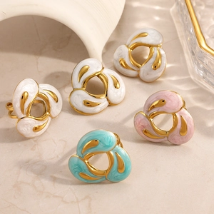 Detailed close-up of hollow petal flower rings in colorful marble enamel and gold finish