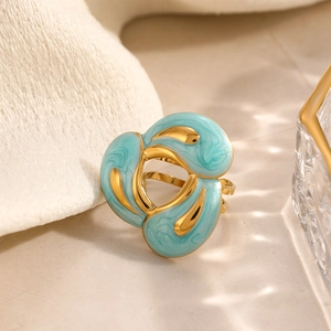 Vintage abstract vortex ring in gold finish with blue marbled enamel texture