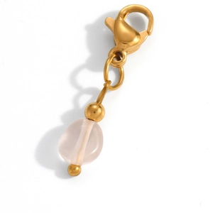 Detailed macro view of a gold lobster clasp with a pale pink translucent gemstone pendant