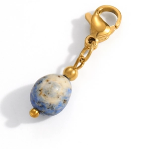 Macro detail of a gold stainless steel lobster clasp pendant with blue marble stone bead