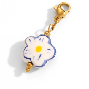 Detail of blue and white flower pendant with gold plating and lobster clasp detail