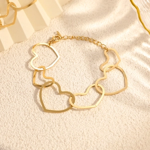 Detailed macro view of 18K gold plated heart-shaped link bracelet with lobster clasp