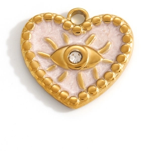 Macro detail of heart-shaped evil eye pendant with pink enamel and gold beaded edges