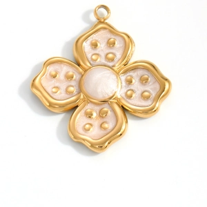 Golden four-leaf flower pendant with white enamel and rivet details on white background