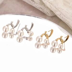 Elegant gold and silver pearl drop earrings with minimalist curved metal triangle design