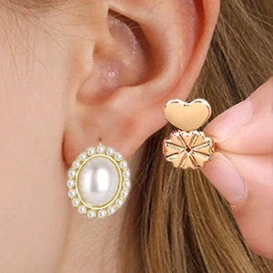 Detail view of heart-shaped earring lifters in rose gold for heavy pearl studs support
