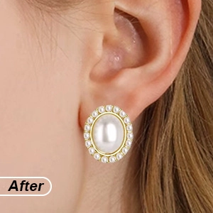 Close-up detail of a vintage oval pearl earring with gold metal base on model ear