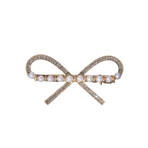 Elegant gold bow hair clip with white pearls and sparkling rhinestones on a white background