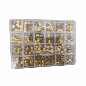Detailed set of golden metal hair braid charms and rings in a 24-grid organizer box
