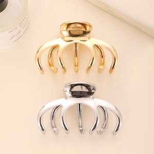 Minimalist gold and silver metal hair claws for women in a premium curved matte finish
