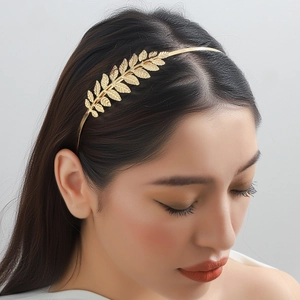Elegant gold laurel leaf headband for women featuring a minimalist polished alloy design