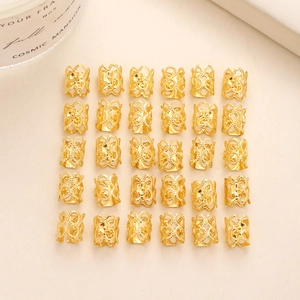 Detailed view of 30pcs gold hollow carved hair braid rings for dreadlocks styling