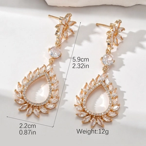 Detail view of gold drop earrings with pear-shaped cubic zirconia and measurement specs