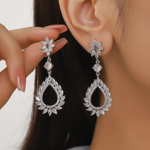 Detailed macro view of elegant silver water drop earrings with micro-set zircon stones